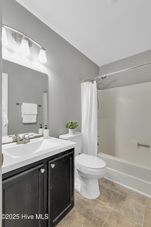 bathroom with vanity, shower / tub combo with curtain, and toilet