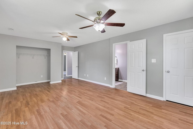 unfurnished bedroom with a closet, baseboards, ceiling fan, connected bathroom, and light wood-style flooring