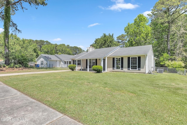 ranch-style house featuring central air condition unit, a front lawn, fence, and a chimney