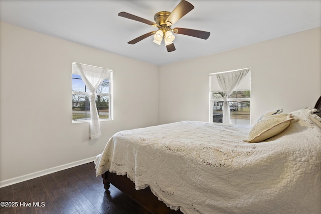 bedroom with a ceiling fan, baseboards, and hardwood / wood-style floors