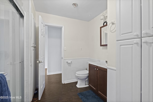 full bathroom featuring vanity, toilet, and wood finished floors