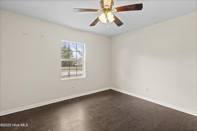 empty room with visible vents, ceiling fan, baseboards, and wood finished floors