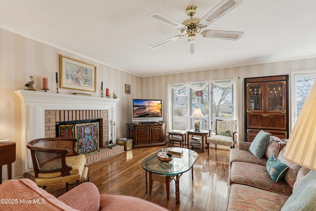 living room featuring a healthy amount of sunlight, crown molding, and hardwood / wood-style flooring