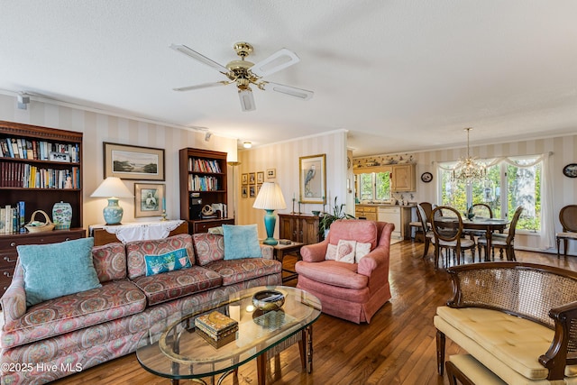 living room featuring ornamental molding, ceiling fan with notable chandelier, and hardwood / wood-style floors