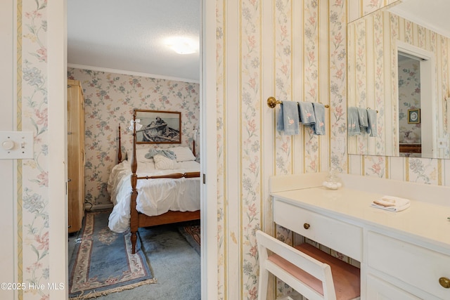 ensuite bathroom with vanity, ornamental molding, ensuite bathroom, and wallpapered walls