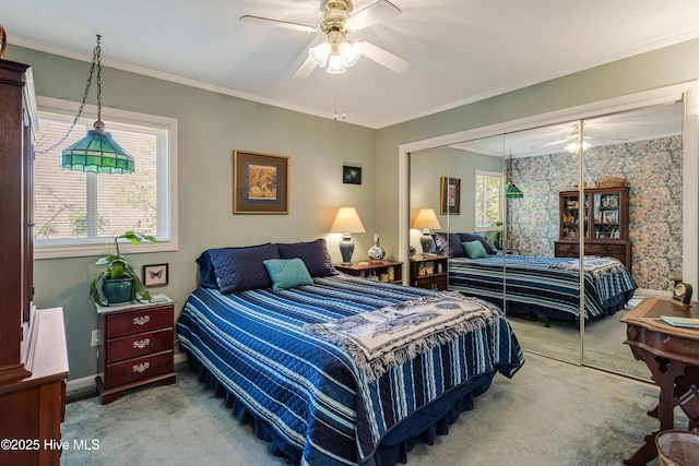 carpeted bedroom featuring wallpapered walls, multiple windows, a closet, and ornamental molding