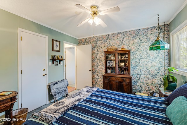 bedroom with a ceiling fan, crown molding, and wallpapered walls