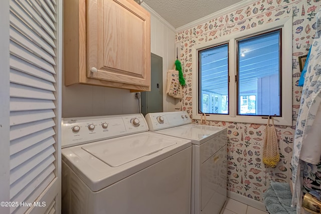 clothes washing area with wallpapered walls, crown molding, cabinet space, a textured ceiling, and independent washer and dryer