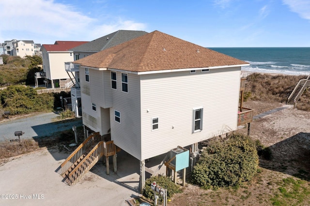 exterior space with a beach view and a water view