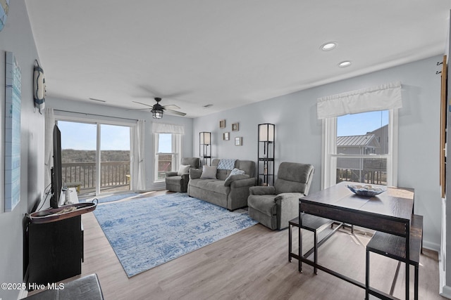 living area with recessed lighting, wood finished floors, and ceiling fan