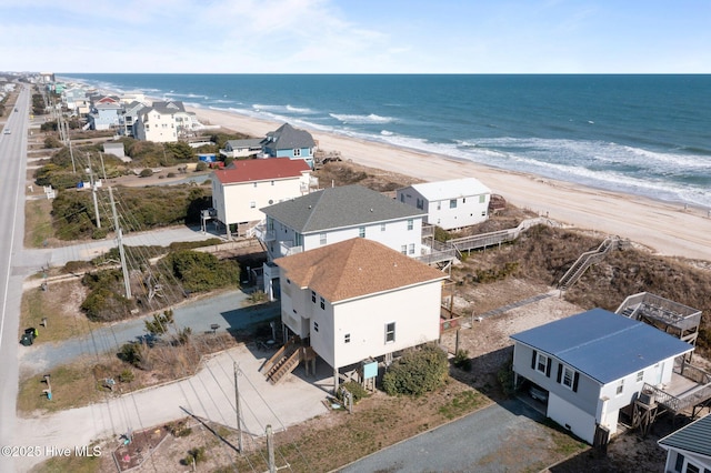 aerial view featuring a beach view, a residential view, and a water view