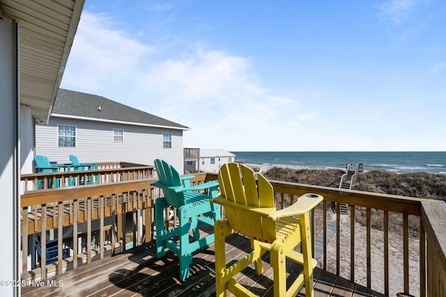 deck with a water view and a beach view