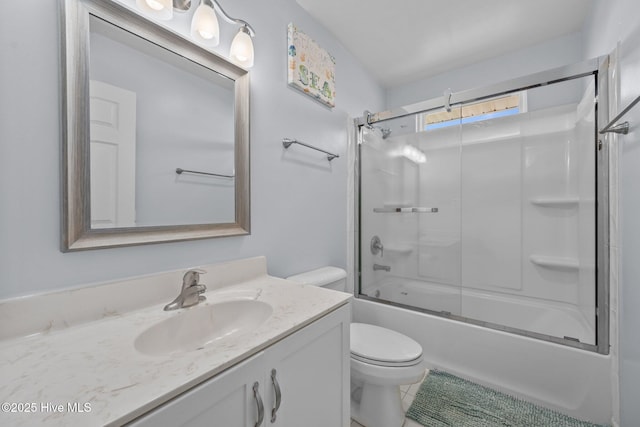 bathroom featuring enclosed tub / shower combo, toilet, and vanity