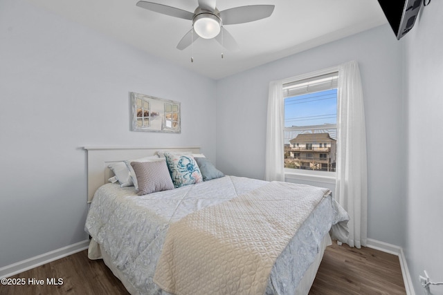 bedroom featuring a ceiling fan, dark wood-type flooring, and baseboards