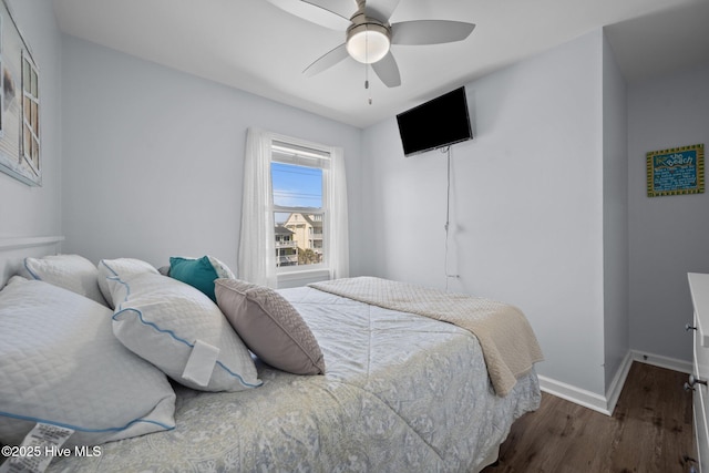 bedroom featuring baseboards, ceiling fan, and dark wood-style flooring