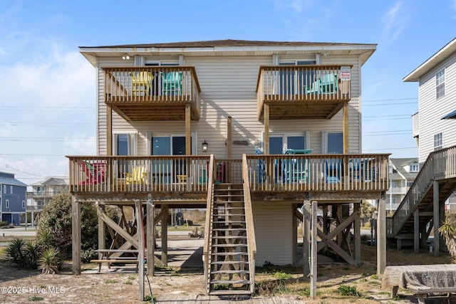 back of property with stairway and a carport