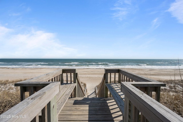 view of community with a beach view and a water view