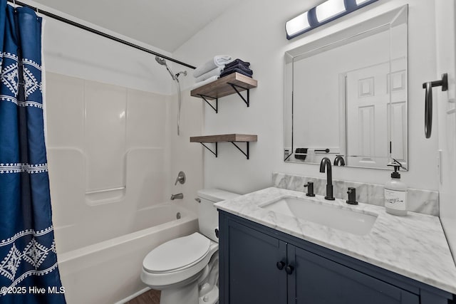 bathroom with vanity, toilet, and shower / tub combo