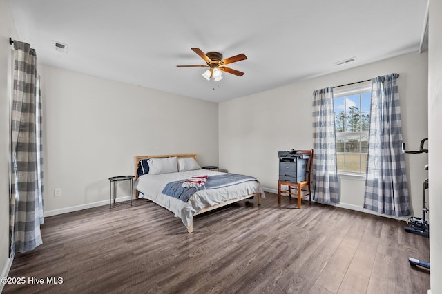 bedroom with visible vents, ceiling fan, baseboards, and wood finished floors