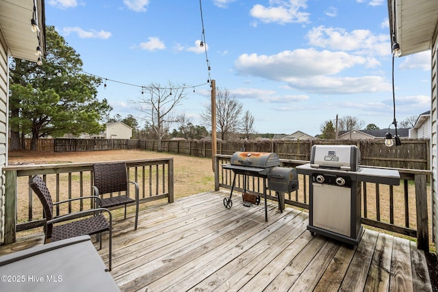 deck featuring a grill and a fenced backyard