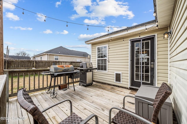 wooden deck featuring area for grilling and fence