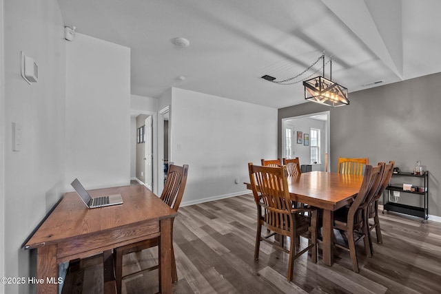 dining space featuring visible vents, baseboards, and wood finished floors