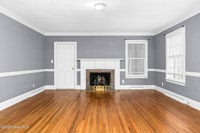 unfurnished living room featuring a premium fireplace, wood finished floors, and ornamental molding