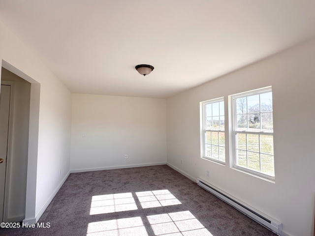 carpeted spare room with baseboards and baseboard heating