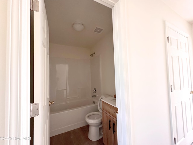 bathroom with visible vents, toilet, shower / tub combination, wood finished floors, and vanity