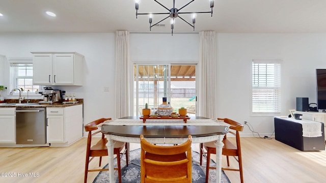 dining space featuring a notable chandelier, recessed lighting, light wood-type flooring, and baseboards