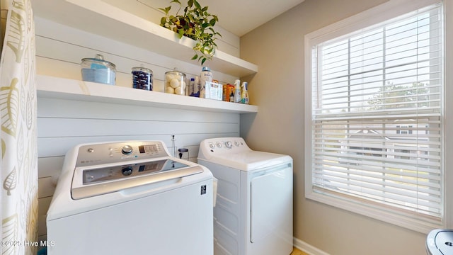 laundry room featuring laundry area, washing machine and dryer, and a healthy amount of sunlight