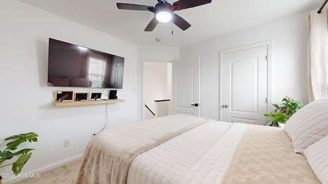 carpeted bedroom featuring ceiling fan and baseboards