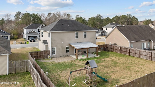 back of house featuring a playground, a yard, a patio area, and a fenced backyard