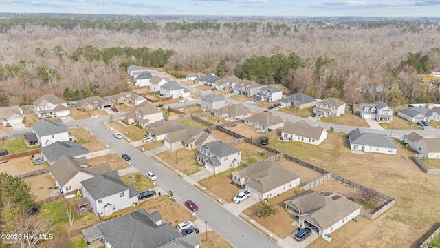 drone / aerial view with a residential view and a view of trees