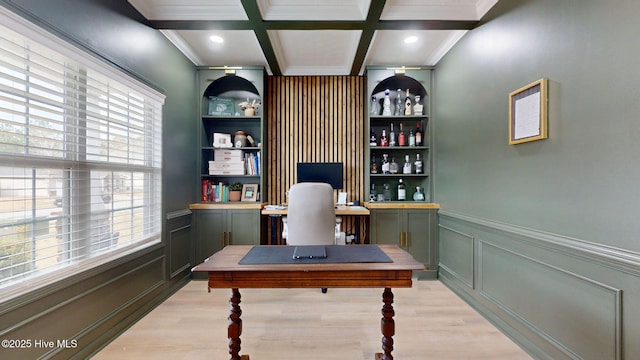 office space with beamed ceiling, coffered ceiling, light wood-type flooring, and crown molding