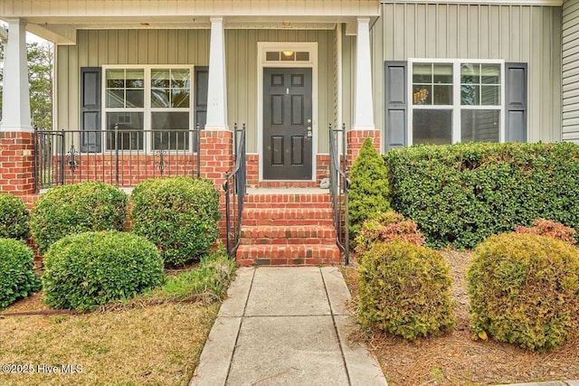 view of exterior entry featuring brick siding