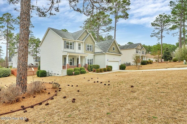 traditional home featuring covered porch and an attached garage