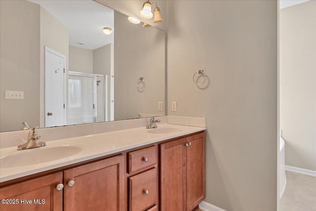 bathroom featuring a sink, baseboards, a stall shower, and double vanity