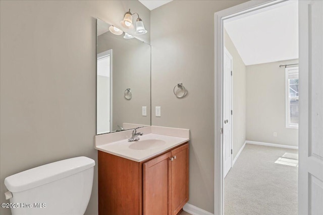 bathroom featuring baseboards, toilet, and vanity