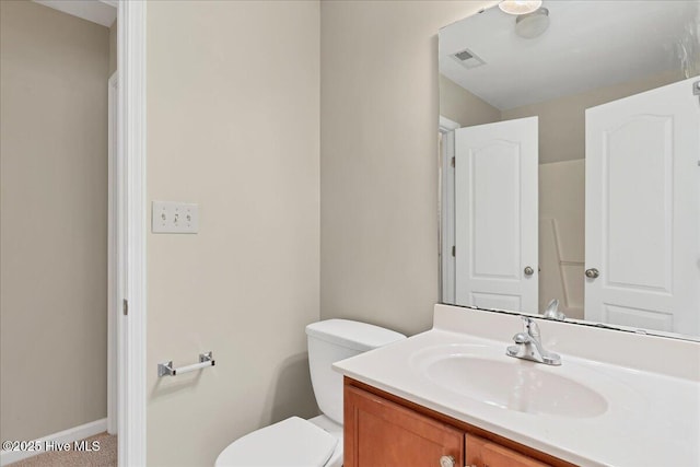 bathroom featuring visible vents, baseboards, toilet, and vanity