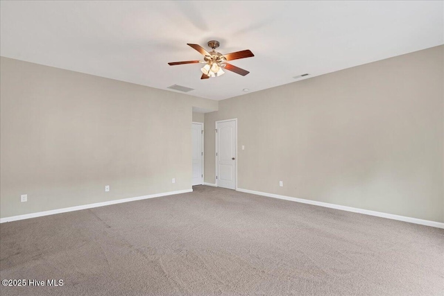 carpeted empty room featuring a ceiling fan, baseboards, and visible vents