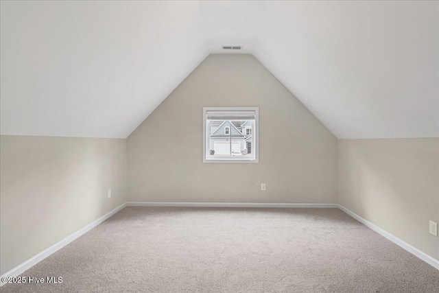 bonus room featuring visible vents, baseboards, lofted ceiling, and carpet