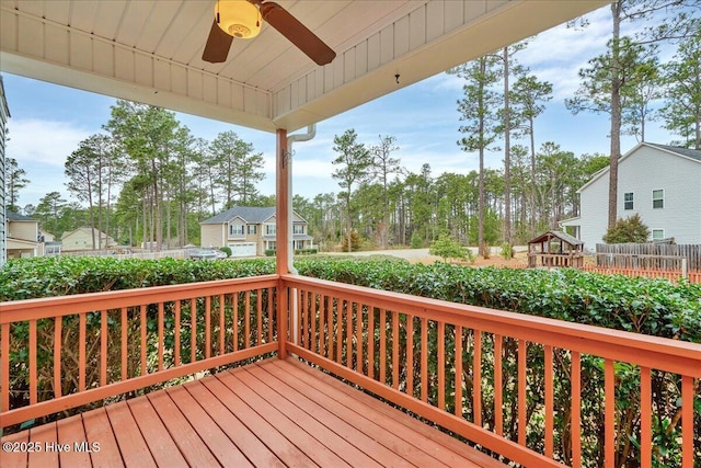 deck with a ceiling fan and fence