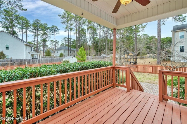 wooden deck with a fenced backyard and a ceiling fan