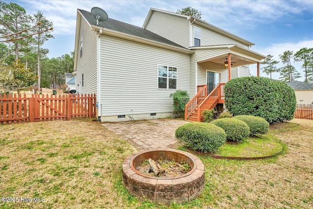 back of house featuring a ceiling fan, fence, a patio area, crawl space, and a lawn