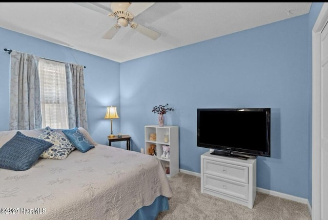 carpeted bedroom with a ceiling fan and baseboards