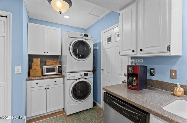 laundry room with a sink, stacked washer and clothes dryer, and laundry area