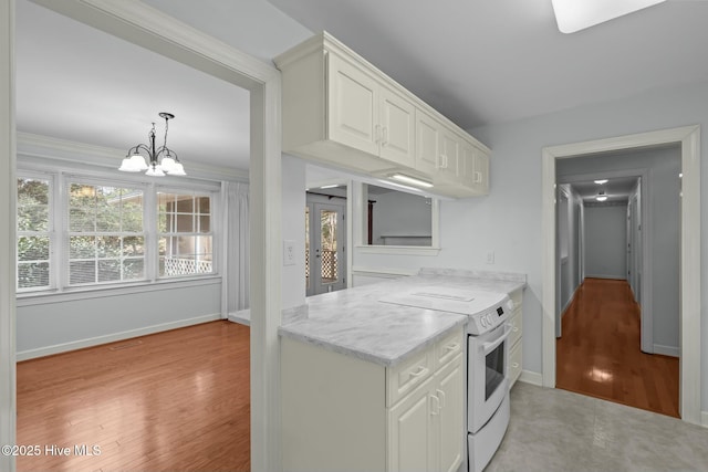 kitchen with baseboards, light wood finished floors, white cabinets, electric stove, and a notable chandelier