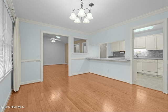 kitchen with light wood-type flooring, tasteful backsplash, white cabinetry, crown molding, and dishwasher