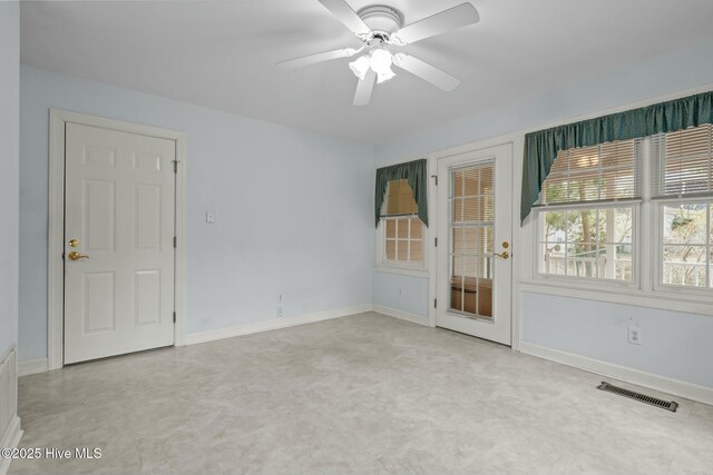 spare room with visible vents, ceiling fan, and baseboards